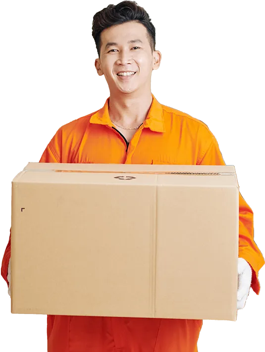 A cheerful mover in an orange jumpsuit and gloves smiling while holding a large cardboard box, representing moving services.